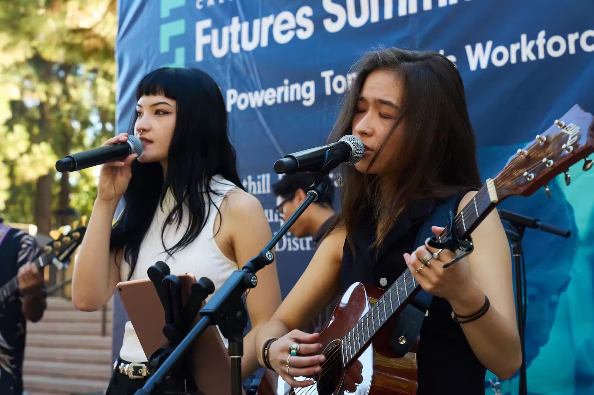 Two women musicians playing outdoors at the Futures Summit